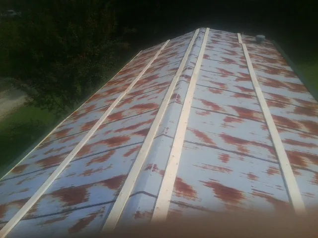 Rusted metal roof panels with new wood purlins before replacement — Storm Damage Roof Repair in North Bloomfield by Roofing Brothers