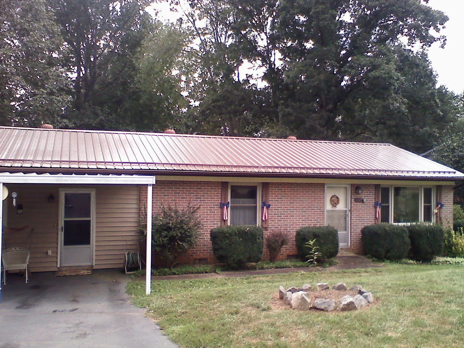 Bronze metal roof and carport on a brick ranch home in North Bloomfield